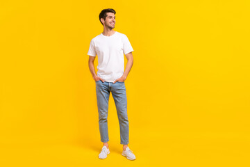 Full body photo of cute young brunet guy stand look ad wear eyewear t-shirt jeans sneakers isolated...