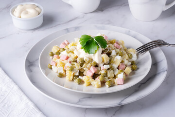 russian olivier salad with chicken decorated with parsley