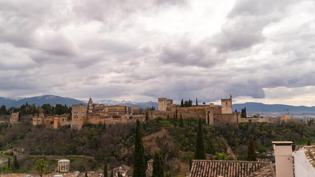 Fast moving timelapse over Alhambra Palace with mountains in Granada, Spain