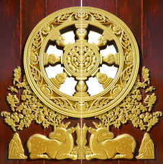 golden deer on door in baromraja temple thailand