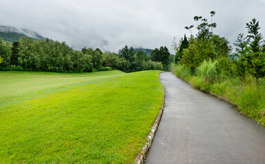 Green golf course with footpath