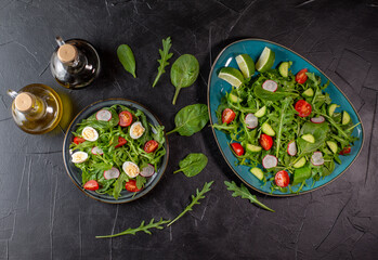 Vegan salad with cherry tomatoes, fresh arugula and quail egg. Concept for a tasty and healthy meal. Vitamins in vegetables and herbs for immunity against the virus. Vegan breakfast, vegetarian food.
