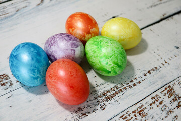 colorful easter eggs on wooden kitchen table close up