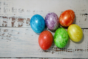 colorful easter eggs on wooden kitchen table close up
