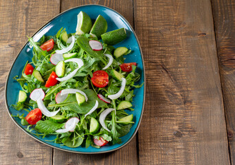 Salad with cherry tomatoes, fresh arugula and quail egg. Concept for a tasty and healthy meal. Vitamins in vegetables. Top view. Flat lay, copy space