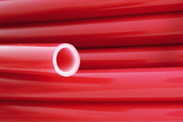 Flexible pipe on underfloor heating made of cross-linked polyethylene with an oxygen barrier. Materials for home insulation. Innovative technology. Installation for comfort and coziness.

 - obrazy, fototapety, plakaty
