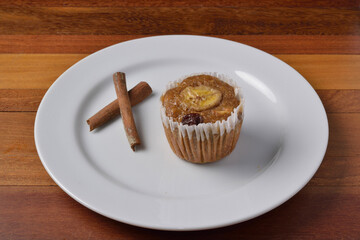Banana muffin with cinnamon on white plate. Brazilian cuisine.