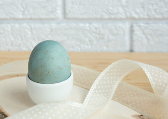 Easter egg on the table on a white background. The concept of Easter decor. Close-up. Selective...