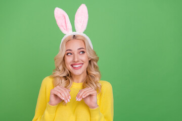 Photo of sweet young blond lady look promo play wear ears yellow pullover isolated on green color...
