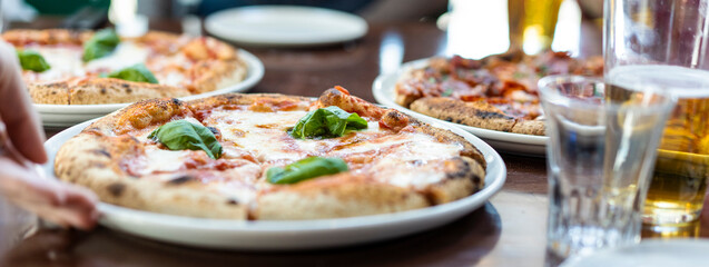 Horizontal banner or header with close up view of a Margherita Neapolitan style pizza with buffalo...