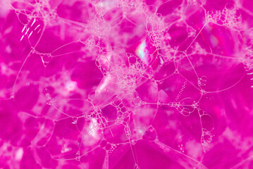 The background of soap bubbles is bright pink or red. Shampoo foam. Bubbles in the water