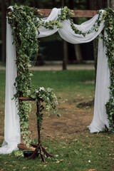 Selective focus. Ceremony, arch, wedding arch, wedding, wedding moment, decorations, decor, wedding decorations, flowers, chairs, outdoor ceremony in the open air.