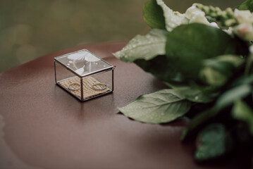 Two gold pieces of wedding rings lie in a beautiful casket. selective focus