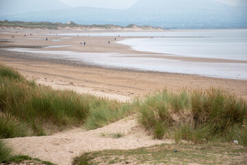Llanddwyn beach on Anglesey Island in north Wales, with Snowdonia mountains seen across the water