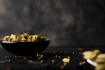 Cardamom in the bowl. Cloves and coriander 