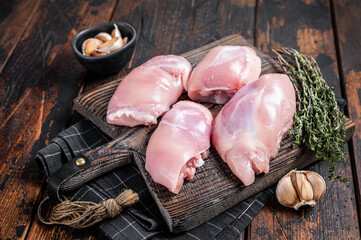 Chicken thigh fillet,  Raw Boneless and skinless meat  on a cutting board. Wooden background. Top view
