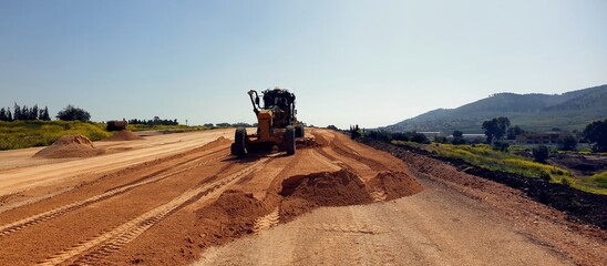 grader at construction site,  earthwork at a construction site, earthwork at a construction site, construction work, roadworks, layer -by-layer of the soil, pavement preparation  © shturman59