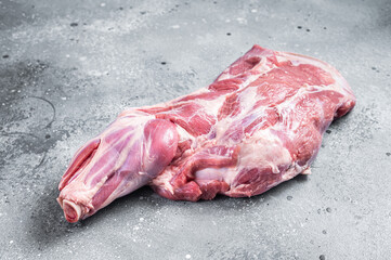 Raw lamb shoulder meat on butcher table. Gray background. Top view