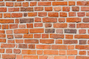 Obraz premium Red brick wall of a medieval building on a sunny day