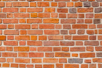 Red brick wall of a medieval building on a sunny day