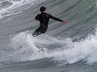 a surfer surf a wave in italy