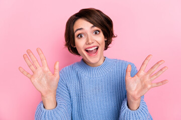 Portrait of funny positive lady hands palms demonstrate number ten open mouth isolated on pink...