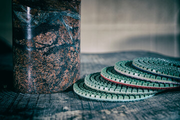 polished multicolored granite cylinder and diamond abrasive polishing pads for stone processing