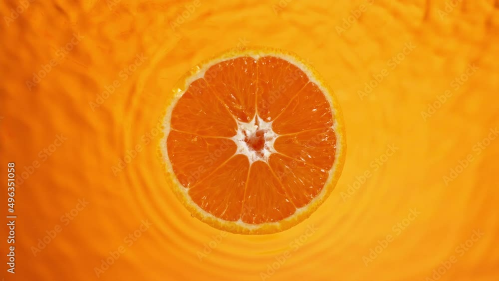 Poster piece of orange on moving liquid surface. macro background. filmed on a high-speed camera at 1000 fp