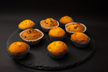 Juicy cupcakes on a black background, confectionery, bakery