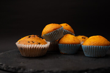 Juicy cupcakes on a black background, confectionery, bakery