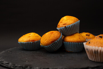 Juicy cupcakes on a black background, confectionery, bakery