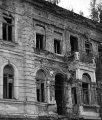 Damaged, destroyed building as a result of the war between Russia and Ukraine. Black and white photography