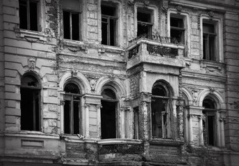 Damaged, destroyed building as a result of the war between Russia and Ukraine. Black and white...