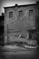 Fototapeta na wymiar Damaged, destroyed building as a result of the war between Russia and Ukraine. Black and white photography
