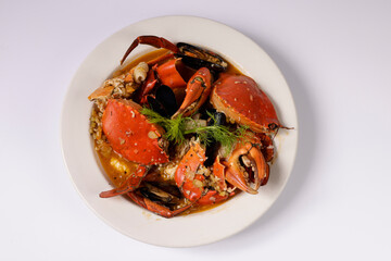 BIG CRAB CIOPPINO CRAB WOKKIN in a dish top view on grey background singapore food