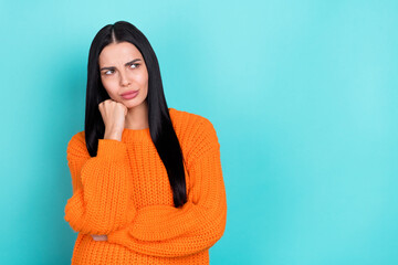 Photo of unhappy upset lady dressed knitted pullover looking empty space arm cheek isolated teal...