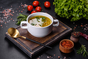 Hot tasty healthy soup with fish and vegetables served on a round plate