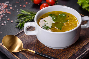 Hot tasty healthy soup with fish and vegetables served on a round plate