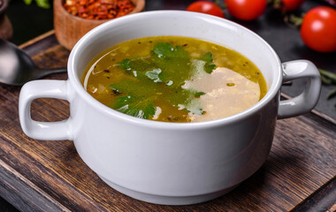 Hot tasty healthy soup with fish and vegetables served on a round plate