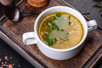 Hot tasty healthy soup with fish and vegetables served on a round plate