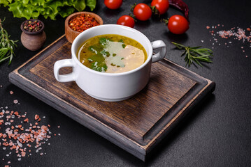 Hot tasty healthy soup with fish and vegetables served on a round plate