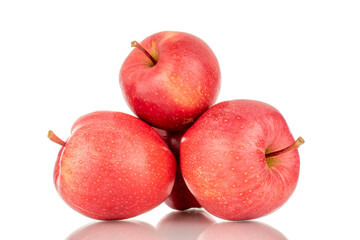 Three ripe red apples, macro, isolated on a white background.