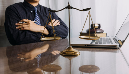 Male lawyer working with contract papers and wooden gavel on tabel in courtroom. justice and law ,attorney, court judge, concept.