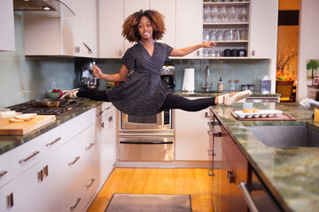 Female ballet dancer cooking in a residential kitchen