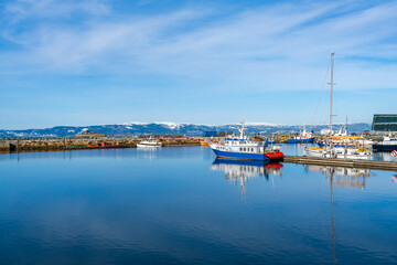 Harbour with moored sailboats and reflections in water, Trondheim, Norway