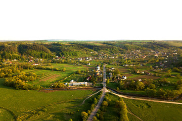 Fototapeta na wymiar Aerial landscape view of village houses and distant green cultivated agricultural fields with growing crops on bright summer day