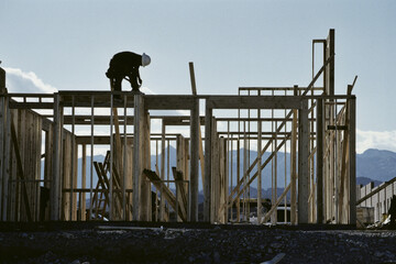 Worker working on the roof of a house under construction