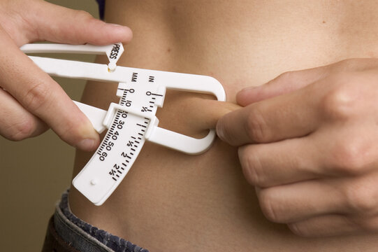 Close-up Of A Person Using A Skin Fold Caliper