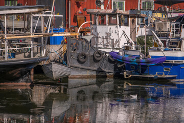 Fototapeta na wymiar Old ships and boats at a wharf on the old previous prison island Långholmen a sunny spring day in Stockholm