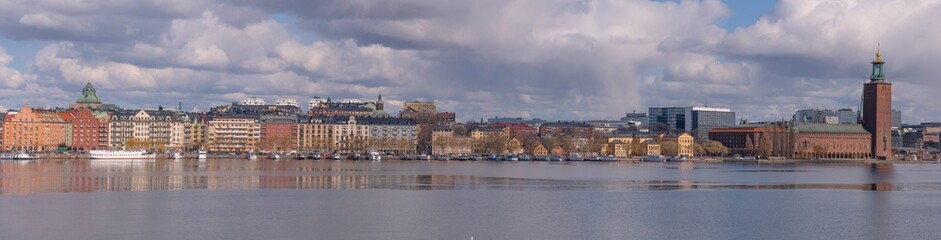 Fototapeta na wymiar Panorama view at the bay Riddarfjärden and the down town buildings with the Town City Hall and a part of the old town Gamla Stan a sunny spring day in Stockholm